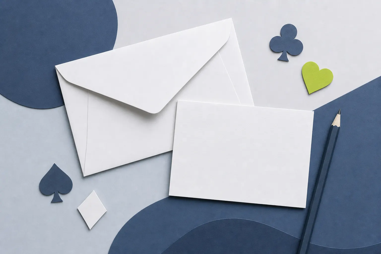 Blank envelope, note card and pencil with small card-suit shapes